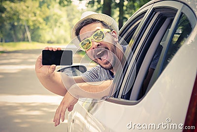 Car driver showing smartphone with blank screen Stock Photo